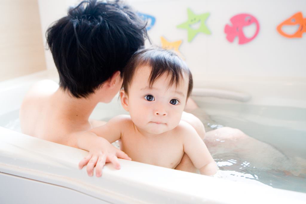 baby and father in bath